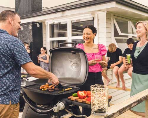 People enjoying a BBQ on deck