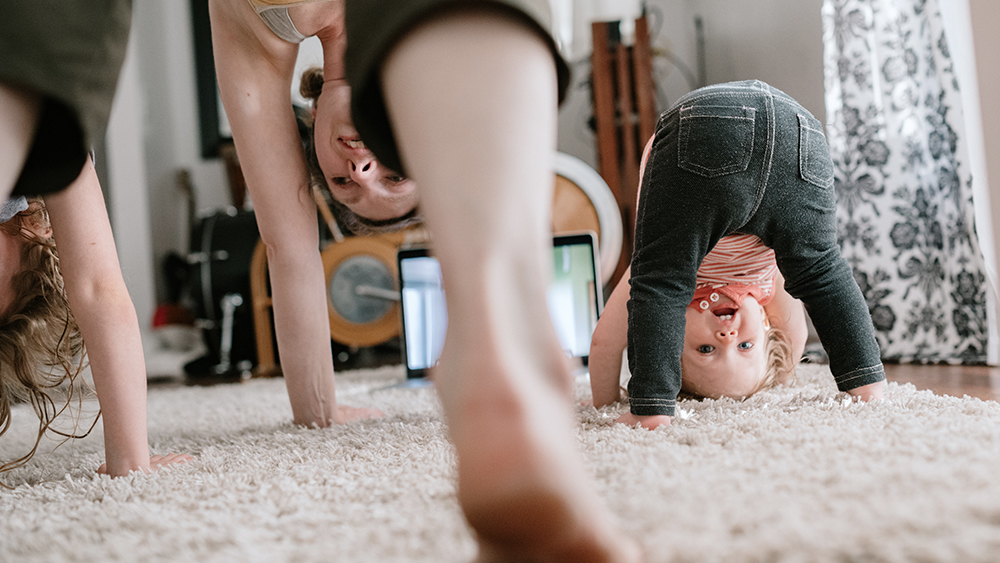 Woman and two children doing an online workout at home