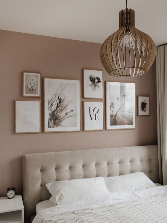 Bedroom with wall art hanging above bed.