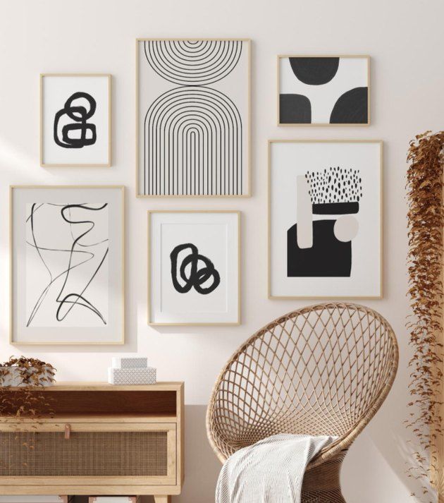 Black and white artworks hanging on a wall.