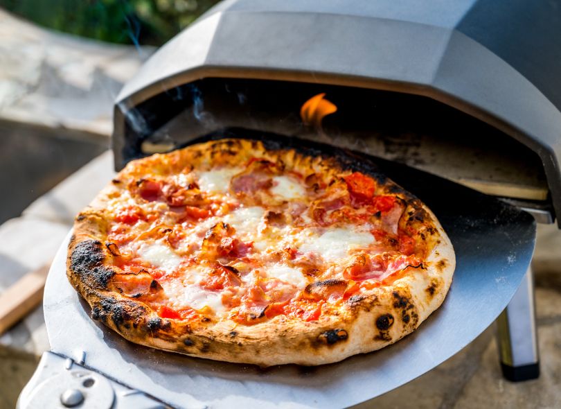 Gas fired pizza oven cooking pizza
