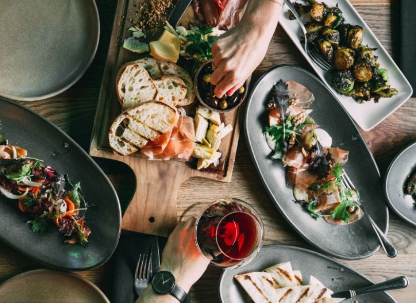 People experiencing shared dining at Social Kitchen.