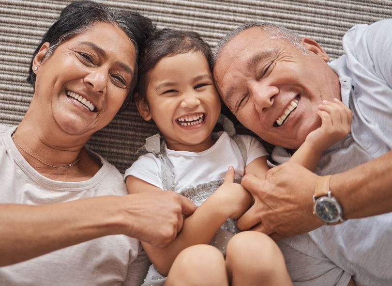 Grandparents laughing with grandchild