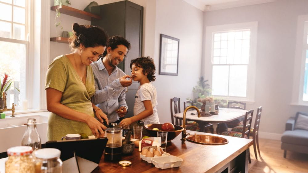 Family having fun preparing a meal in the kitchen.