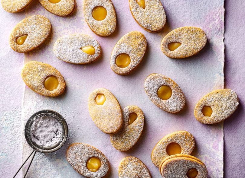 Egg shaped Lemon and Poppy biscuits sandwiched with lemon cured.