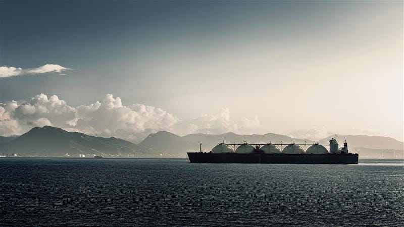 boat in water with mountains in back ground
