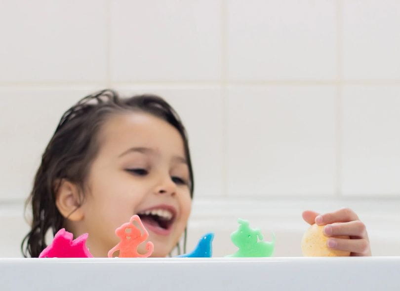 Girl in bath playin with Bath Sprudels.