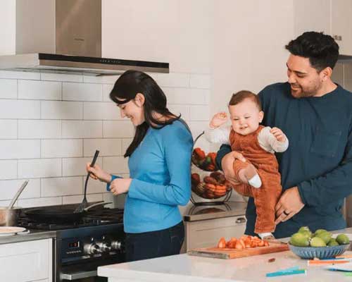 Family cooking in the kitchen on a gas hob