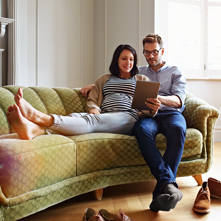 Couple on couch with iPad filling out connection application