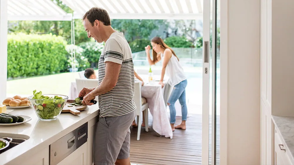 Man and woman preparing food in kitchen