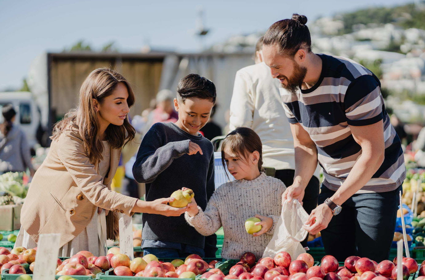 family shopping at fruit market