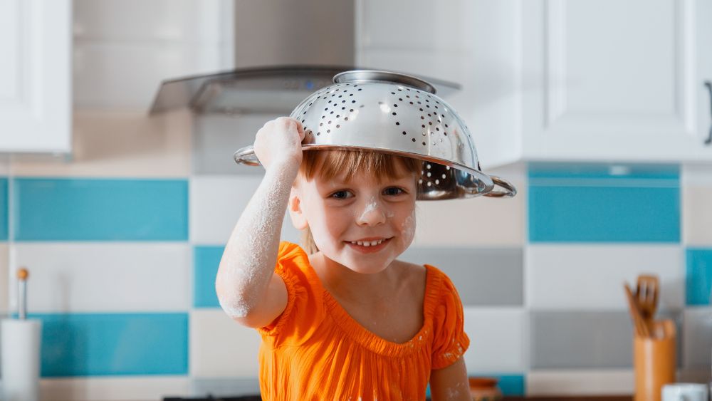 Girl with colander on her head.