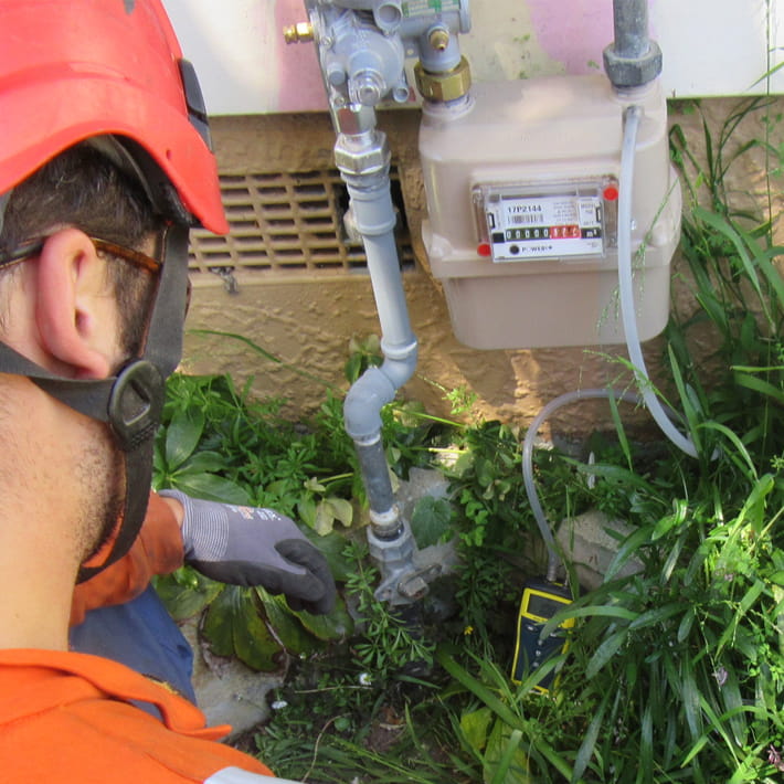 Gasfitter checking gas meter