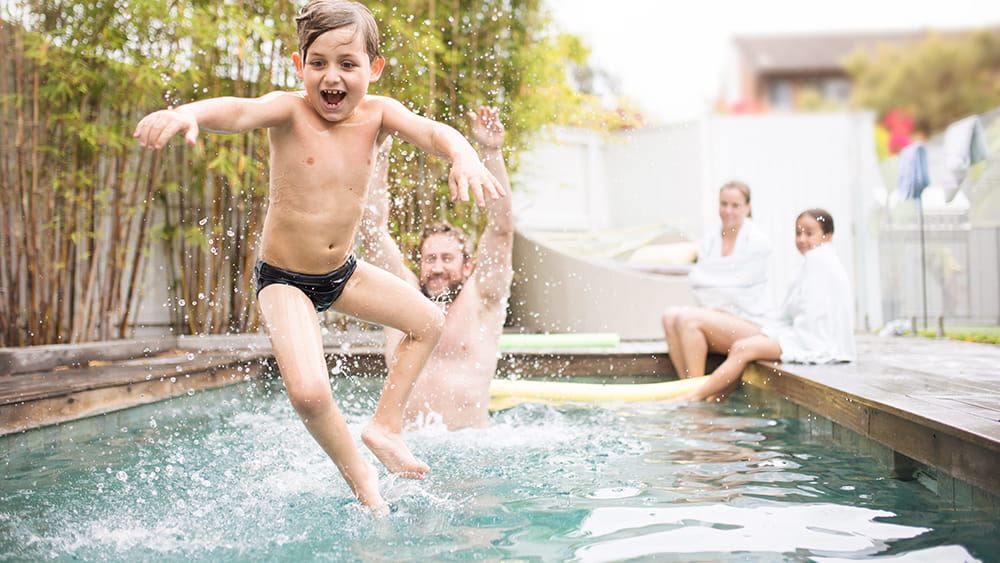 Family playing in pool