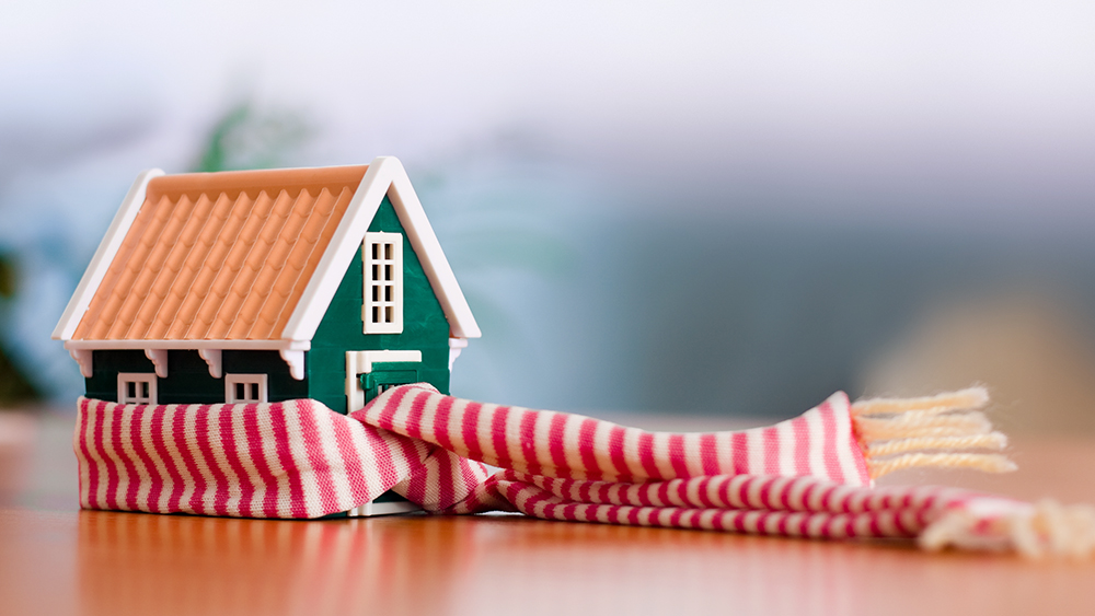 Miniature house wrapped in scarf