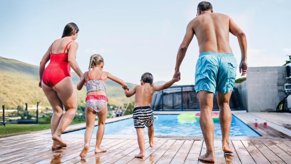 Family walking towards swimming pool.